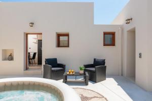a living room with a hot tub and chairs at Antica Casa Dei Nonni with Heated Jacuzzi in Archangelos