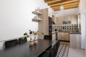 a kitchen with a black counter top in a room at Antica Casa Dei Nonni with Heated Jacuzzi in Archangelos