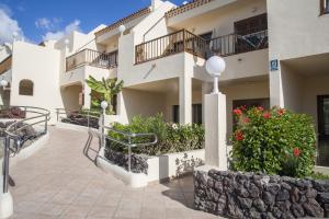 a view of a building with flowers and plants at Royal Sunset Beach Club in Adeje