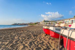 a group of boats sitting on a sandy beach at Royal Sunset Beach Club in Adeje
