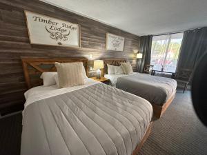 a hotel room with two beds in a room at Timber Ridge Lodge - Walking Distance from Downtown Gatlinburg in Gatlinburg