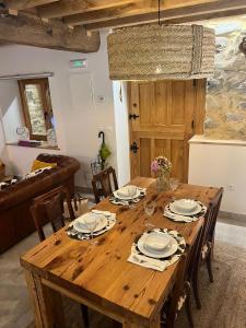 a wooden table in a living room with a dining room at APARTAMENTOS KERCUS in Sevares