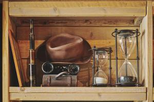 a wooden drawer with a cowboy hat and glasses and a clock at The Legacy by 2GO4 City Center in Brussels