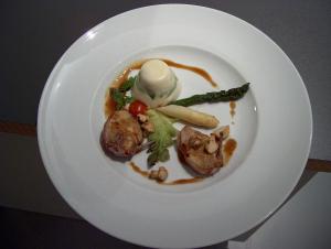 a white plate with a dish of food on it at Zur Windmühle Restaurant - Hotel in Beckum