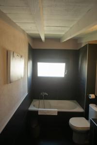 y baño con bañera y aseo. en Loft 35a, en Tesalónica
