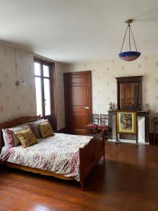 a bedroom with a large bed in a room at The Little Robin in Chevanceaux