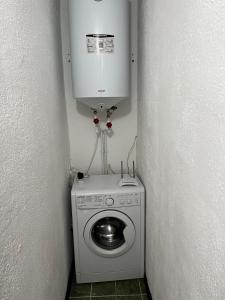 a small washing machine in a corner of a room at Ухоженная и уютная квартира!!! in Tiraspol