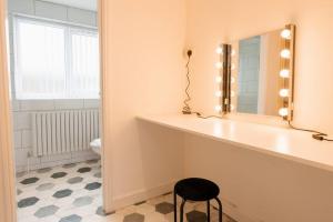 a bathroom with a counter with a mirror and a stool at Prenton House, 3BR Close to Liverpool in Birkenhead +19 photos