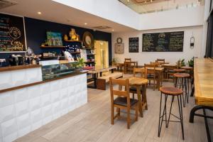 a restaurant with tables and chairs and a bar at Paradise 1 bedroom Apartment @Embassy Gardens in Cantonments