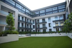 an apartment building with a lawn in front of it at Paradise 1 bedroom Apartment @Embassy Gardens in Cantonments