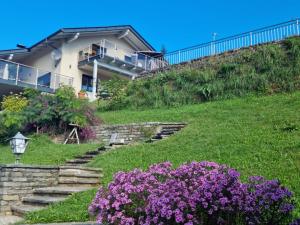 a house on a hill with purple flowers at Ferienwohnung Pirker in Spittal an der Drau