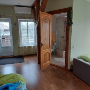 a room with a door leading to a bathroom at Apartamenti Dundaga XXL in Dundaga