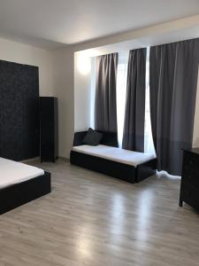 a bedroom with two beds and a large window at Only Ladies hostel - female only in Prague