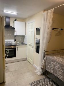 a small kitchen with a bed in a room at Grangemill Garden Annex in Forest Hill