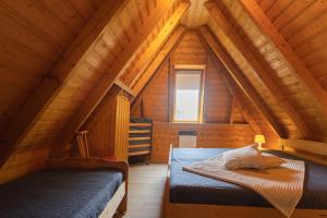 1 Schlafzimmer mit 2 Betten in einem hölzernen Dachgeschoss in der Unterkunft VS 7 - Strandvogt Standard in Dorum Neufeld