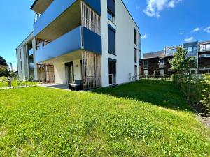 a building with a green lawn in front of it at Graz Getaway in Graz