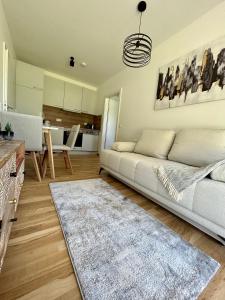 a living room with a couch and a kitchen at Graz Getaway in Graz