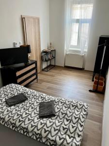 a bedroom with a bed and a wooden floor at Sušilova 14 apartments III in Přerov