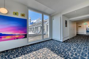 Habitación vacía con ventanas grandes y vistas al océano. en ibis budget Hotel Luzern City en Luzern