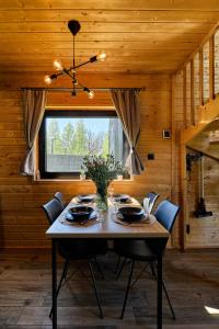 a wooden dining room with a table and chairs at Sielski Chill Mazury in Olsztynek