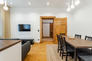 a kitchen and dining room with a table and chairs at Two Bedroom Very Berry Apartment in Poznań with Desk by Noclegi Renters in Poznań