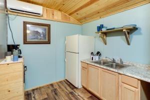 a kitchen with a white refrigerator and a sink at Peaceful Alton Vacation Rental with Grill! 