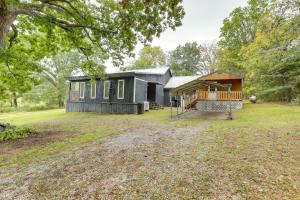 a small house with a playground in the yard at Peaceful Alton Vacation Rental with Grill! 