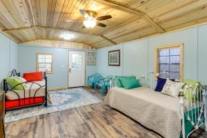 a bedroom with two beds and a ceiling fan at Peaceful Alton Vacation Rental with Grill! 