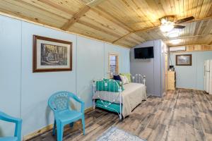 a bedroom with a bed and a ceiling fan at Peaceful Alton Vacation Rental with Grill! 