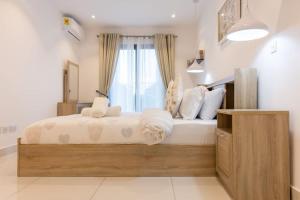 um quarto com uma cama grande e uma janela em Plush 1 Bedroom/Guest Washroom @The Lennox Airport em Acra