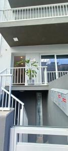 een huis met een balkon met een plant erop bij 54 ONE by RW San Julian's in St Julian's