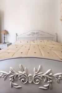 a white bed in a white room with a bed frame at Aegean Diamonds Boutique Villas in Loutraki
