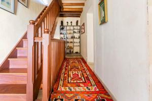a hallway with a rug on the floor at Escapade dans la campagne toulousaine in Beaumont-sur-Lèze