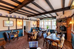 a restaurant with tables and chairs in a room at Blacksmiths Arms Inn in Scarborough