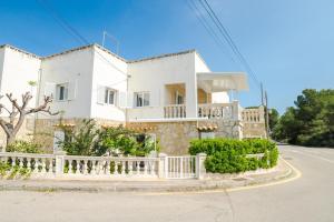 a white house with a fence in front of it at Paris in Alcudia