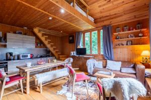 a living room with a couch and a table at Quiet and Authentic Mountain Chalet in Saint Pierre en Faucigny +18 photos