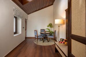a hallway with a dining room with a table and chairs at Brij Anayra Dharamshala - A Himalayan Luxury Retreat in Dharamshala
