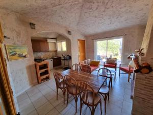 - une cuisine et une salle à manger avec une table et des chaises dans l'établissement CORSACASA Villa in Palombaggia sea view, à Porto-Vecchio