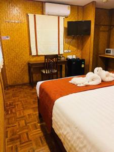 um quarto de hotel com duas camas com toalhas em Danieli Resort em Hua Hin