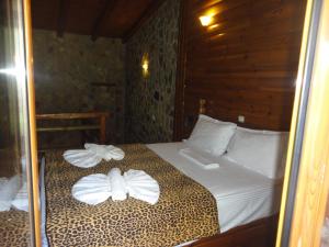 a bedroom with a bed with towels on it at Κalavrita eco View in Kalavrita