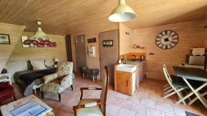 a room with a bed and a kitchen in a cabin at Chambres d`hôtes Le Plessis in Broye