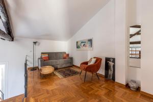 a living room with a couch and a chair at Cathedral View Loft by Wonderful Italy in Palermo +5 photos