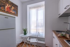 a small kitchen with a table and a window at Cathedral View Loft by Wonderful Italy in Palermo