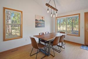 a dining room with a wooden table and chairs at 1 Sunrise in Sunriver