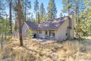 a small house in the woods with a patio at 1 Sunrise in Sunriver