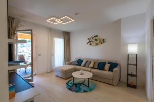 a living room with a couch and a table at Portopiccolo Avolare Apartments in Borgo in Sistiana