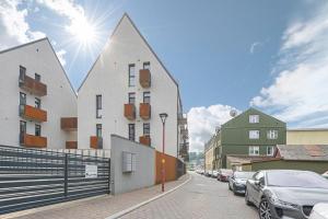 a street with cars parked on the side of a building at Comfortable 1 BD Old Town Apartment by Hostlovers in Kaunas