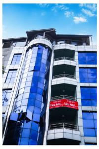 a building with a red sign on the side of it at Yaksa Hotel Pvt. Ltd. in Kathmandu