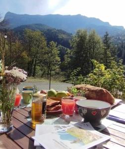 a table with food and drinks on a table with a view at La Sabaudia in Saint-Pierre-dʼEntremont
