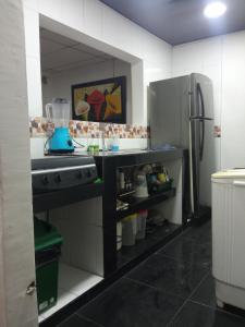 a kitchen with a counter and a refrigerator at Casa CamiMar, Casa Amoblada solo para tí y tú familia in Santa Marta
